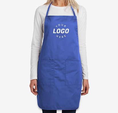 Woman wearing a royal blue bib apron with a logo on the chest