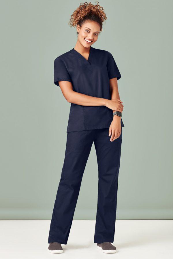 Woman wearing a navy V-neck scrub top and matching scrub pants
